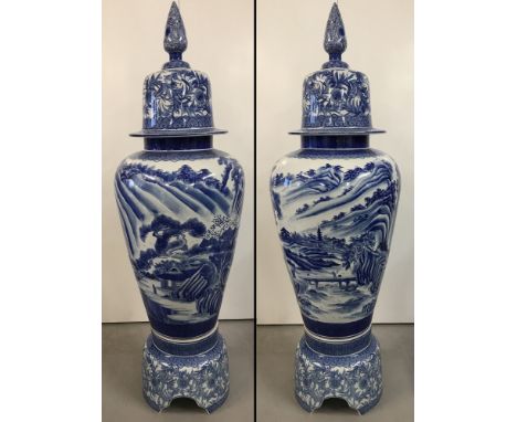 A very large Chinese blue and white ceramic lidded urn on a separate pedestal base. Hand painted with Chinese landscape scene