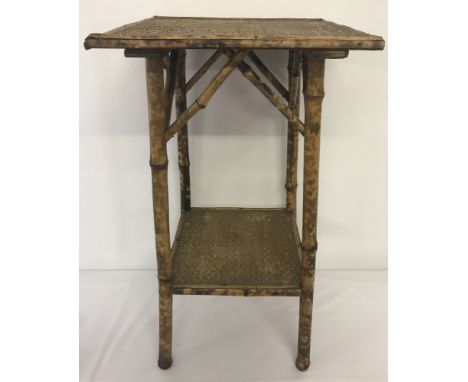 A small vintage bamboo side table with shelf.   Approx. 66cm tall.