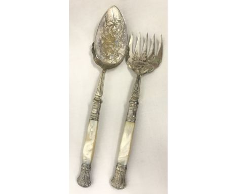A 5 prong pearl handled fish serving fork, together with a matching serving spoon.  
