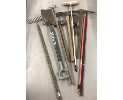 A quantity of vintage and modern long handled garden tools.  To include: hoe, pickaxes, sledgehammer, spade and rake. 