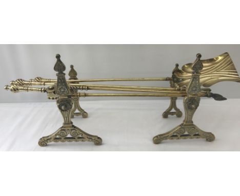 A pair of Victorian brass decorative fire dogs together with a set of fire irons.  Fire Irons have ornamental twisted finial 