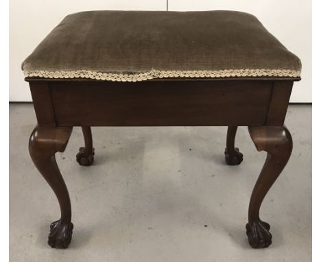 A vintage mahogany piano stool with cabriole style legs and ball and claw feet.  Velvet upholstered lift up lid. 