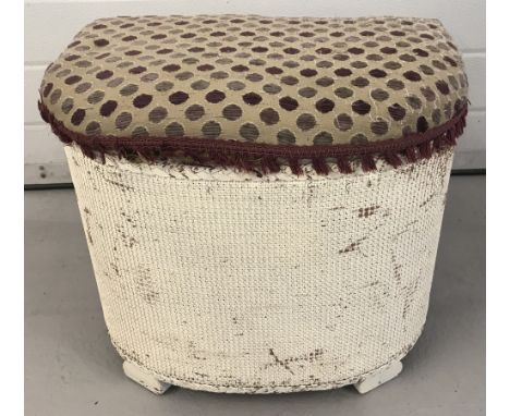 A vintage Lloyd Loom style curve fronted linen basket painted white.  With spotted upholstery to seat lid.  Approx. 42cm tall