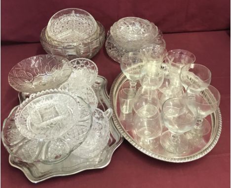A collection of vintage glassware with 2 silver plated serving trays.  To include punch glasses, cake stands, bowls and sunda