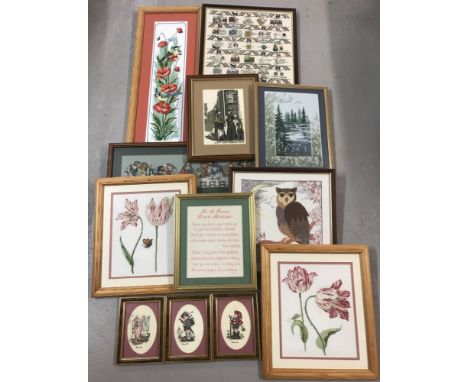 A collection of 12 assorted framed and glazed cross stitch pictures.  To include floral sprays, birds, images of Hummel child