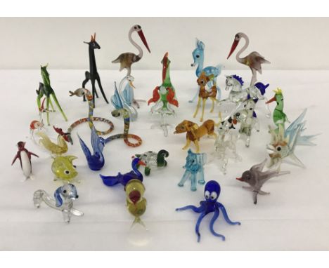A collection of small vintage glass animal figurines.  To include dogs, birds, snakes, fish and horses. 
