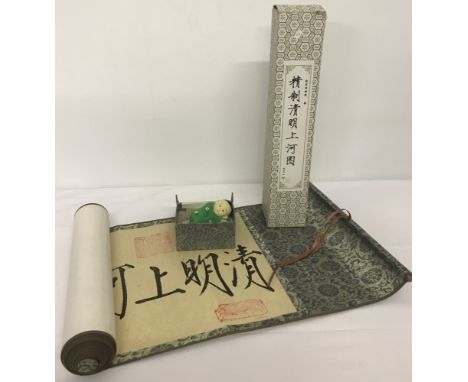 2 boxed vintage Chinese items.  A silk covered wall hanging scroll, together with a ceramic Chinese baby ornament. 
