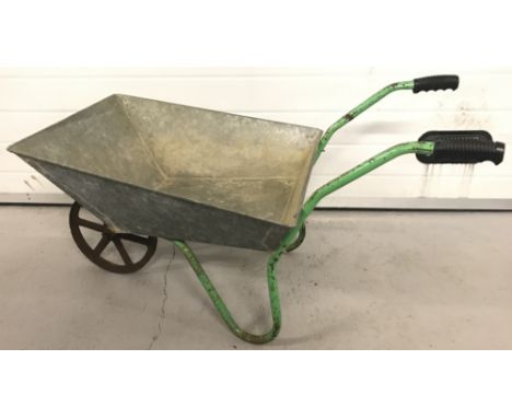 A vintage galvanised wheelbarrow with 6 spoke cast iron wheel.  