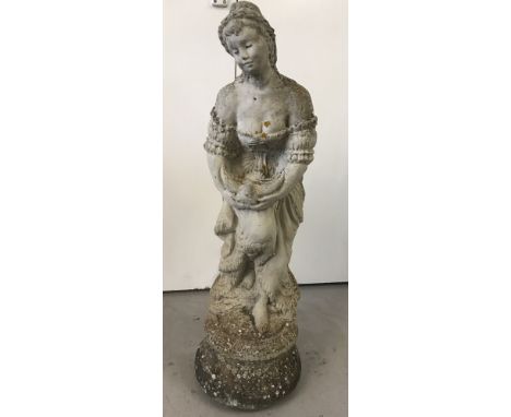 A heavy vintage concrete garden ornament of a classical lady carrying a dove.   Approx. 83cm tall.