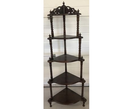 A dark wood 5 tier corner wotnot with bobbin style column detail.  Turned feet finials and carved detail to back. Approx. 143