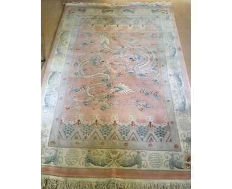 A vintage Chinese pure wool rug. In pastel pink &amp; green tones, with dragon design. Originally purchased from Harrods for 