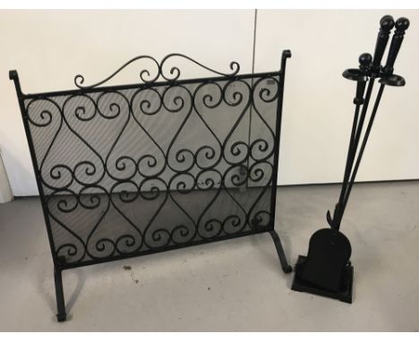 A black wrought iron fire screen and companion set.  Fire screen has scroll detail with mesh backing. 4 piece companion set, 