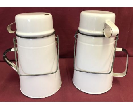 2 vintage white enamel billy cans with metal handles and removable cup lid.   Approx. 19cm tall.