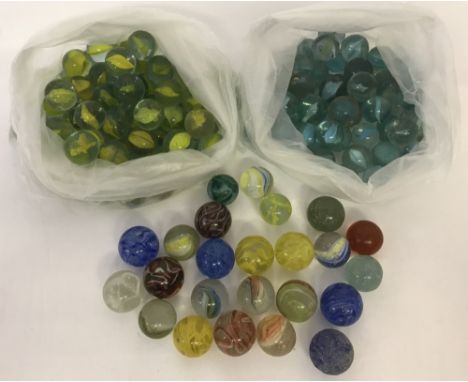A collection of vintage marbles to include yellow, green and blue cats eye's, Swirlies and clearies.  