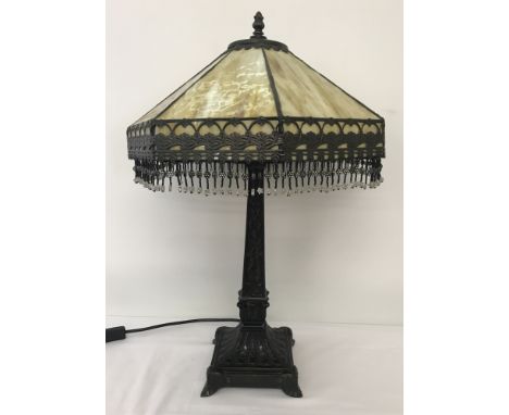 A Tiffany style table lamp with mottled cream/brown glass shade with beaded fringe decoration.  Square foot base with classic