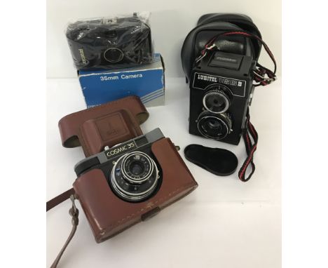 A vintage Soviet Lomo Lubitel 166B duo lens camera.  Together with a cased Cosmic35 camera and a boxed Prixcolor 35mm Camera.