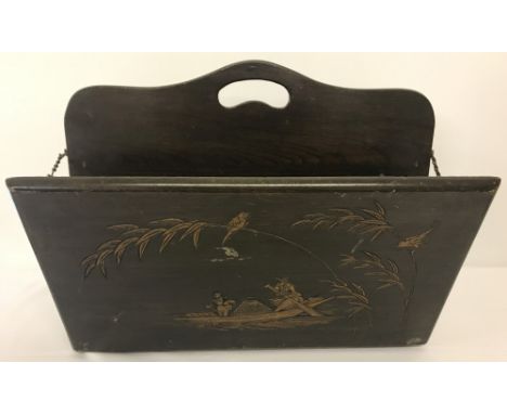 A vintage Chinese wooden magazine rack with carved detail to each side.  Approx. 34cm tall x 46cm wide.