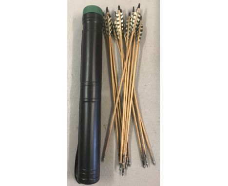 A set of 12 handmade wooden 26" steel-tipped arrows with black and white fletchings.  In a black plastic arrow case with gree