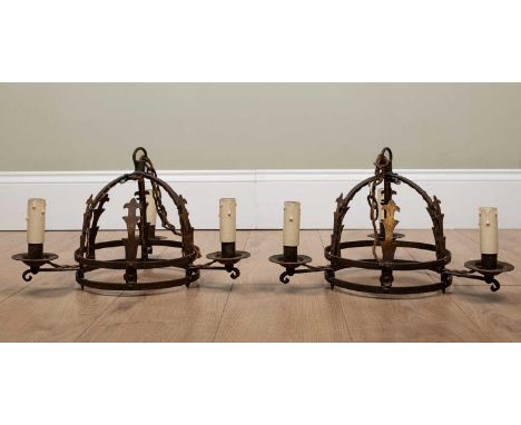 A pair of old wrought iron hanging light fittings, each with three branches and each approximately 27cm highOxidisation overa