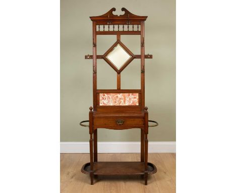 A Victorian walnut hall stand with various hooks and central mirror above a tiled back over a single drawer with stick stands