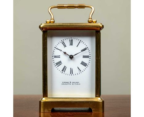 A small carriage timepiece, the enamel dial signed 'Cooke &amp; Kelvey, Calcutta &amp; Paris', 12.5cm high with the handle do