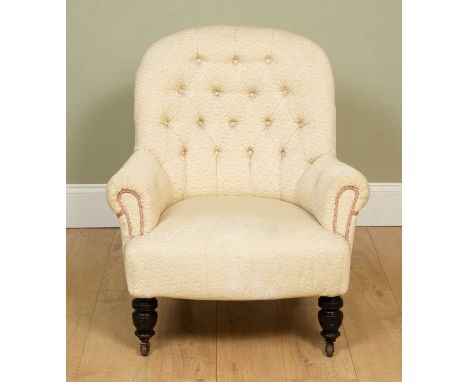 A 19th century nursing chair with turned tapering front legs and ceramic casters, the cream upholstery with buttoned back, 76