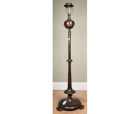 A lamp standard of coppered finish, originally an oil lamp, later converted for electric use, 141cm highOxidisation and in ne