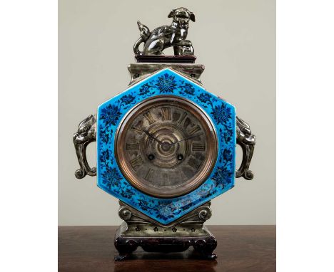 An Aesthetic Movement pottery case mantle clock having a Roman dial and twin train bell striking movement, the hexagonal case