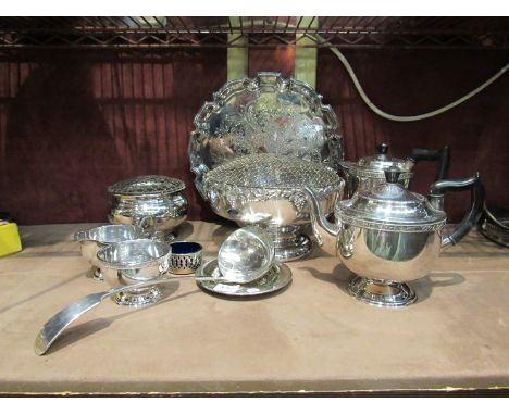 A box containing silver plated items including teapots, a ladle, applied fruit design rose bowl etc