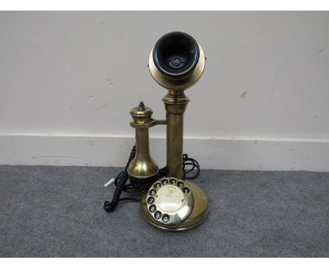 A brass candlestick telephone 