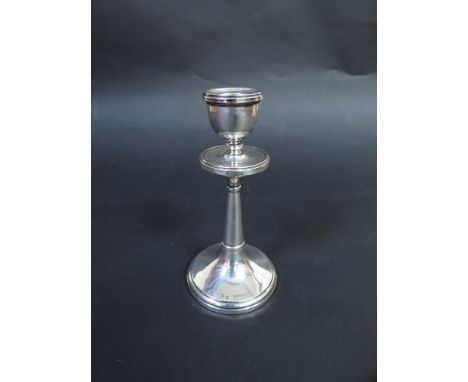 A silver candlestick with integral drip tray, Birmingham 1919, maker indistinct, weighted base, 14cm tall  