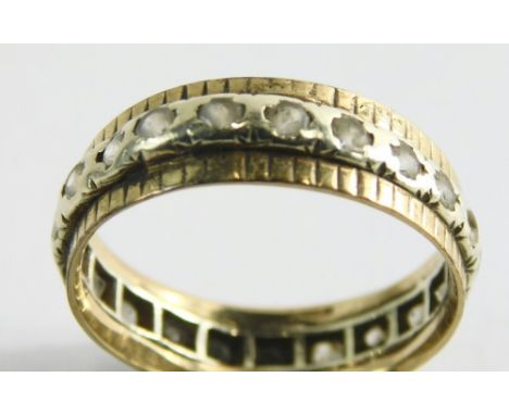 A 9ct gold and silver eternity ring, the central band set with silver with cz stones, with two yellow gold borders, ring size