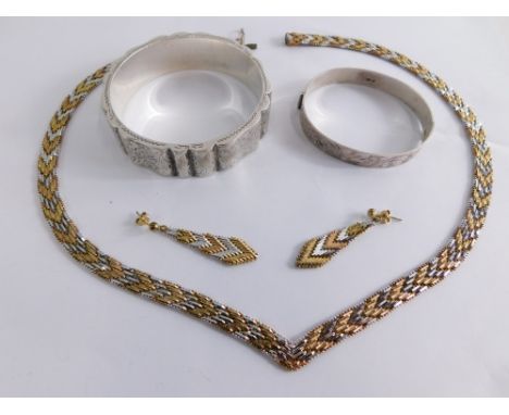 Two silver bangles, comprising of a engraved and flared vase, engraved torque bangle, 57g all in, and a bicolour link neck ch