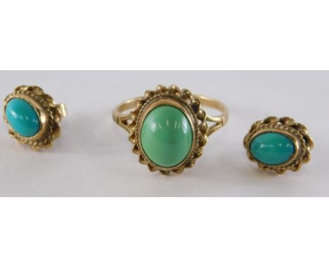 A 9ct gold turquoise dress ring, the cabochon set turquoise in a raised rub over setting, with rope twist, ring size M½, 2.4g