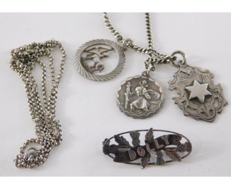 A group of silver jewellery, comprising silver St. Christopher pendant and chain, a silver circular pendant and chain depicti