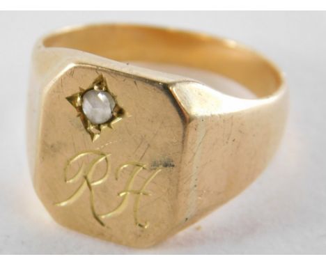 A signet ring, with octagonal panel, set with tiny diamond in illusion setting, bearing the initials RH, yellow metal, unmark