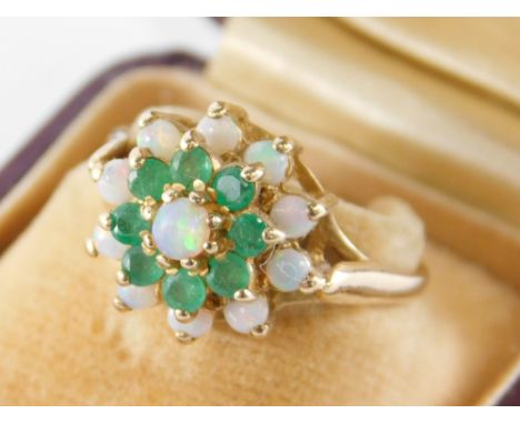 A 9ct gold cluster ring, of three layer design, set with opal and emerald, in a raised basket setting, ring size P, 3.6g all 