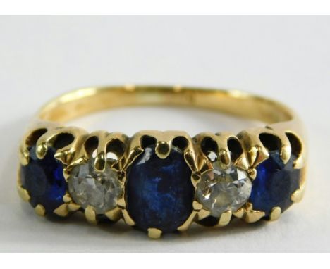 An 18ct gold sapphire and diamond gypsy ring, set with three sapphires, one oval in claw setting and two round brilliant cut 