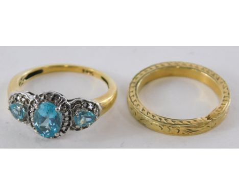 Two dress rings, comprising a wedding band of hammered design, yellow metal unmarked and a topaz and diamond dress ring, yell