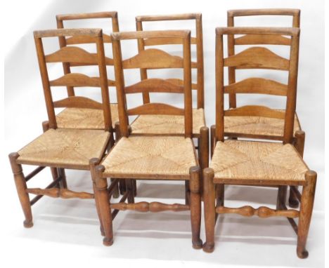 A matched set of six Lancashire ash and elm ladder back chairs, with rope seats, on turned front legs joined by  horizontal f
