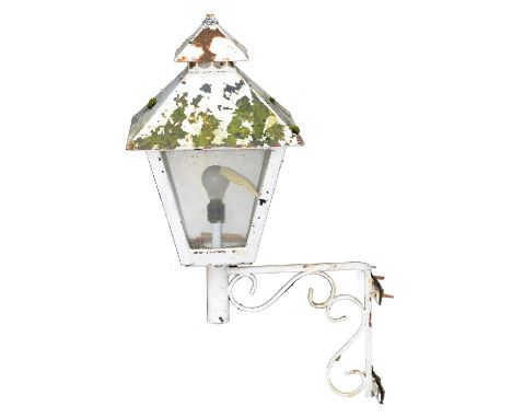 A painted metal street or drive lantern, mounted on a wrought iron bracket, overall height 95cm h  Paint chipped showing rust