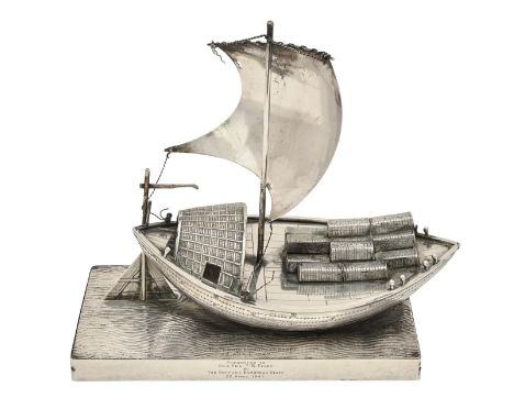 An Indian silver model of a Ganges river boat, laden with bales each engraved with a signature, the rectangular base with rip