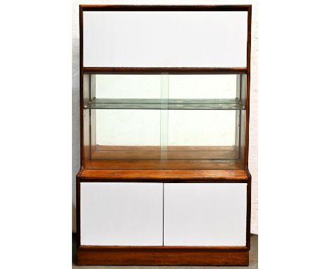 A teak drinks cabinet, c1970, enclosed by sliding glass doors, full front laminate doors, 141cm h; 41 x 92cm  Good condition