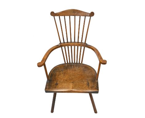 An unusual British ash and fruitwood comb-back Windsor chair, first half 19th c, with substantial shaped seat, 95cm h &nbsp;O