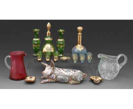 A Venetian enamelled and gilt blue glass carafe and stopper and set of four glasses and a similar green glass suite of glass,
