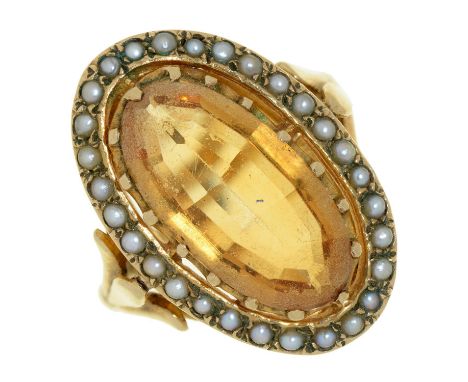 A citrine ring with split pearl surround, in gold, indistinctly marked, 6g, size M  Good condition