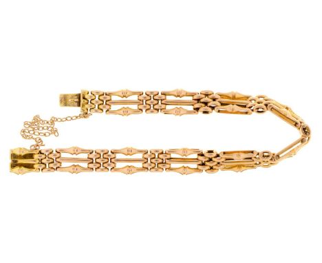 A gold gate bracelet, early 20th c, 18cm l, marked 15ct, 20.4g  Light wear consistent with age