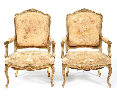 A pair of French giltwood armchairs, late 19th c, in Louis XV style, upholstered in contemporary Aubusson floral tapestry ove