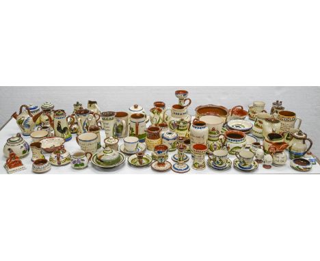 A collection of Torquay pottery, first half 20th c, to include motto ware, jugs and candlesticks, various sizes and marks (ap