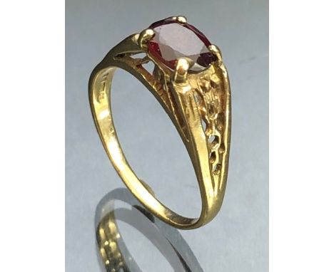 9ct Gold ring set with a faceted garnet on a raised gold setting size approx 'V'